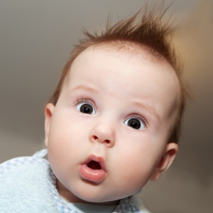 Cute 4 months old baby making a funny surprised face